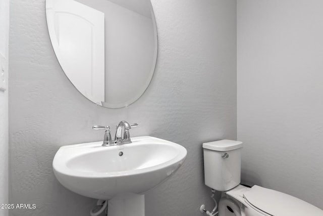 bathroom with toilet and sink