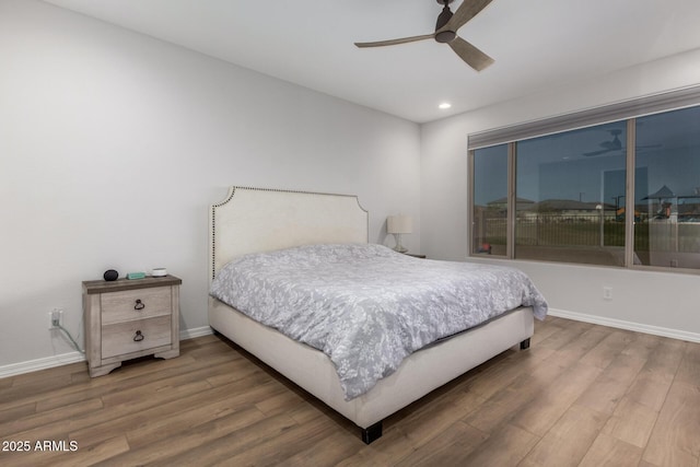 bedroom with ceiling fan and hardwood / wood-style floors