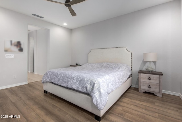 bedroom with hardwood / wood-style floors and ceiling fan