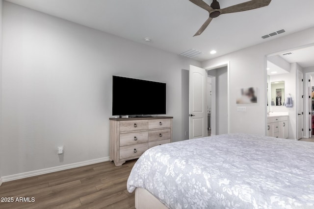 bedroom featuring ceiling fan, ensuite bathroom, and light wood-type flooring