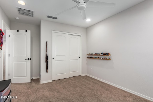 unfurnished bedroom featuring a closet, ceiling fan, and carpet flooring