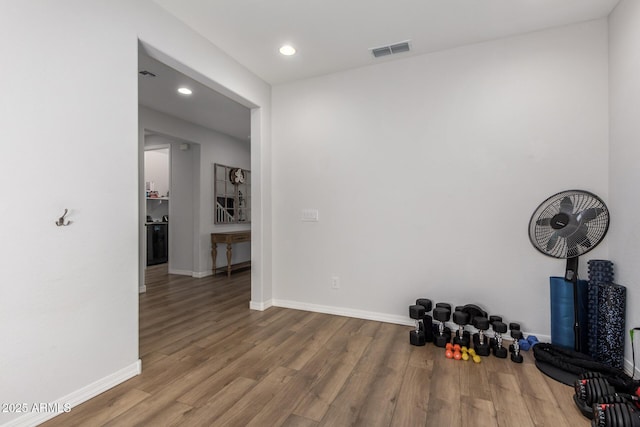 exercise area featuring hardwood / wood-style flooring