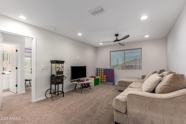 carpeted living room featuring ceiling fan