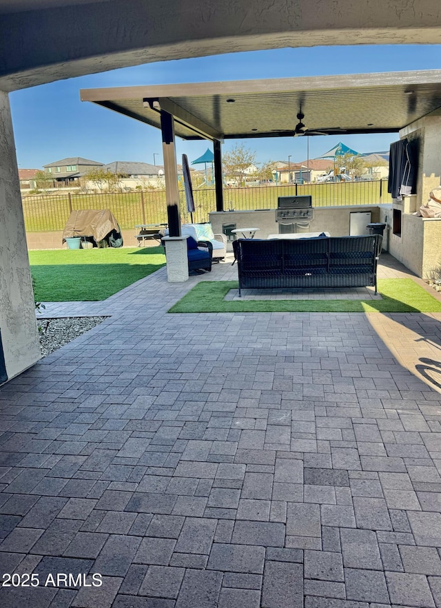 view of patio / terrace with ceiling fan, area for grilling, a grill, and outdoor lounge area