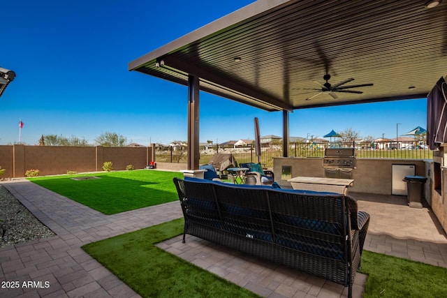 view of patio / terrace featuring ceiling fan, an outdoor kitchen, an outdoor hangout area, and area for grilling