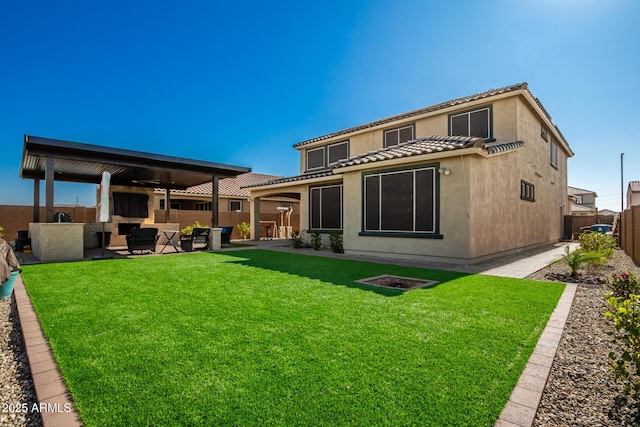 back of house featuring an outdoor living space, a yard, a patio, and ceiling fan