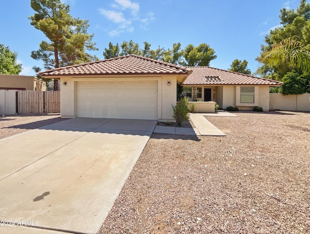 mediterranean / spanish-style home with a garage