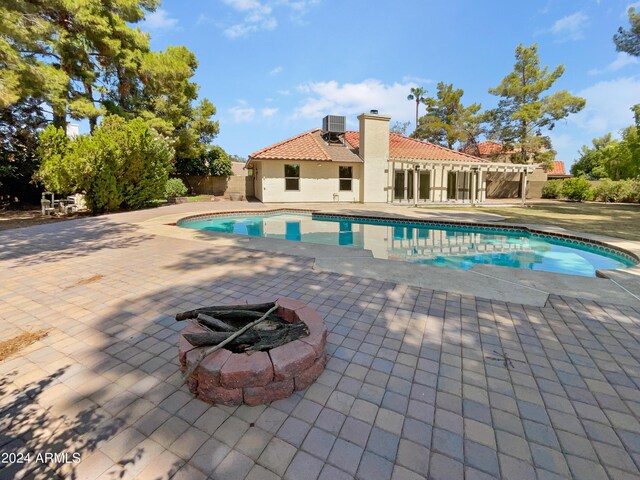 view of swimming pool featuring cooling unit, a yard, and a patio area