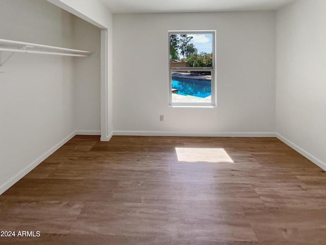 empty room with wood-type flooring