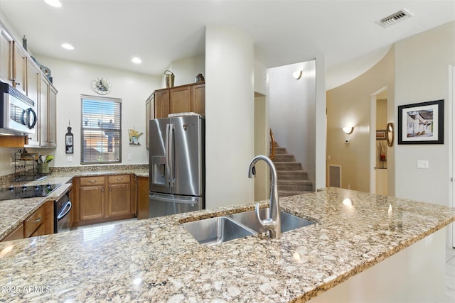 5370 S Desert Dawn Dr Unit 56, Gold Canyon, AZ 85118 - kitchen featuring stainless steel appliances, light stone counters, brown cabinetry, and recessed lighting