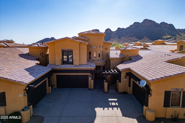 5370 S Desert Dawn Dr Unit 56, Gold Canyon, AZ 85118 - view of front of home featuring a mountain view, a garage, stucco siding, driveway, and french doors