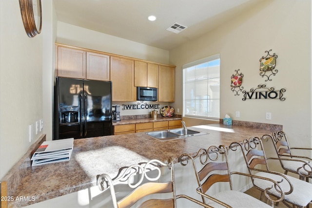 5370 S Desert Dawn Dr Unit 56, Gold Canyon, AZ 85118 - kitchen with black appliances, light brown cabinets, a peninsula, a breakfast bar, and recessed lighting