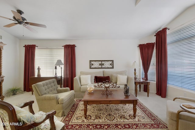 carpeted living room featuring a ceiling fan