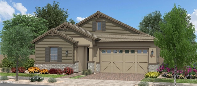 view of front of house featuring decorative driveway, stone siding, and stucco siding