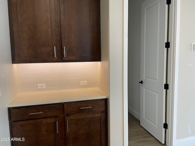 interior space with decorative backsplash and wood finished floors