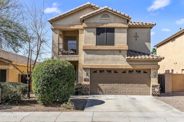 view of front of property with a garage, driveway, a balcony, and stucco siding