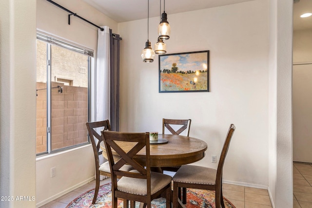 dining space with light tile patterned floors and baseboards