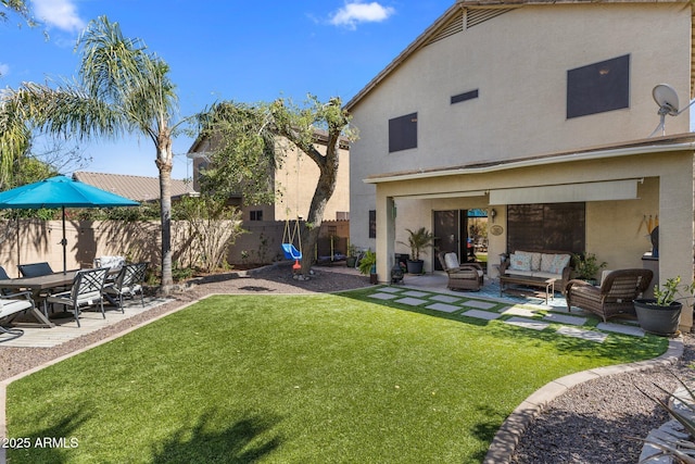 view of yard featuring fence, outdoor lounge area, and a patio