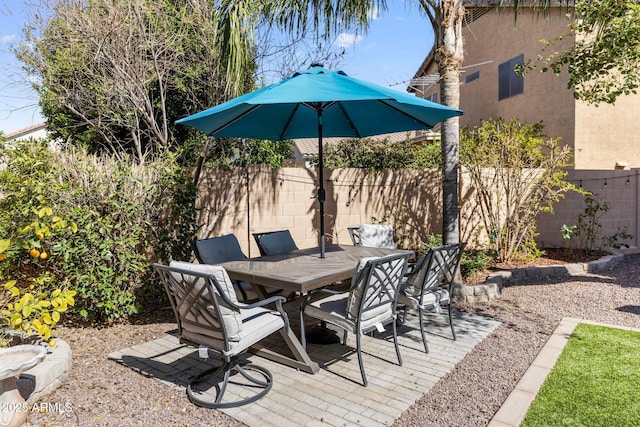 view of patio featuring outdoor dining area and fence