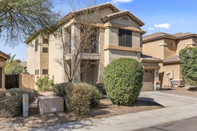 view of front of property with a tile roof, driveway, and stucco siding