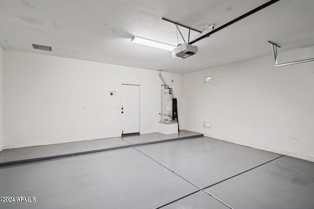 garage featuring a garage door opener and water heater