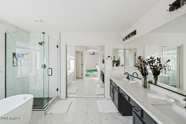 full bath featuring a marble finish shower, marble finish floor, a freestanding bath, and a sink