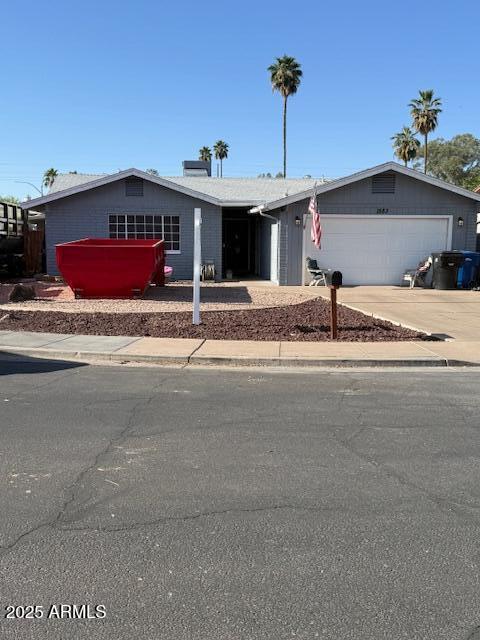 1553 E Flower Cir, Mesa, AZ 85204 - ranch-style home featuring a garage, driveway, and a chimney