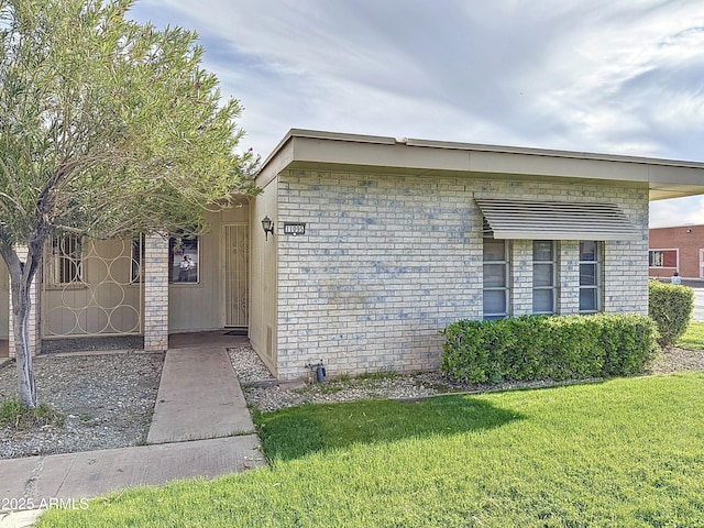 1553 E Flower Cir, Mesa, AZ 85204 - view of front facade with a front lawn and brick siding