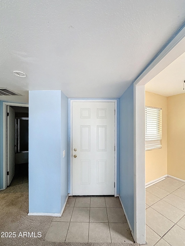 1553 E Flower Cir, Mesa, AZ 85204 - foyer featuring light tile patterned flooring, baseboards, and a textured ceiling
