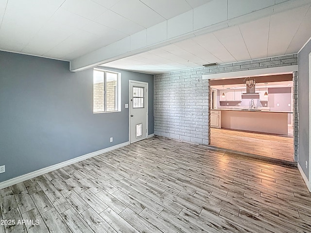 1553 E Flower Cir, Mesa, AZ 85204 - unfurnished living room with wood finished floors, baseboards, and a sink