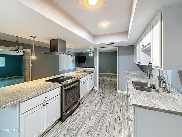 1553 E Flower Cir, Mesa, AZ 85204 - kitchen with stainless steel range with electric cooktop, a sink, island exhaust hood, white cabinets, and a tray ceiling
