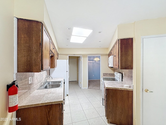 1553 E Flower Cir, Mesa, AZ 85204 - kitchen featuring white appliances, a sink, tasteful backsplash, light tile patterned flooring, and light countertops