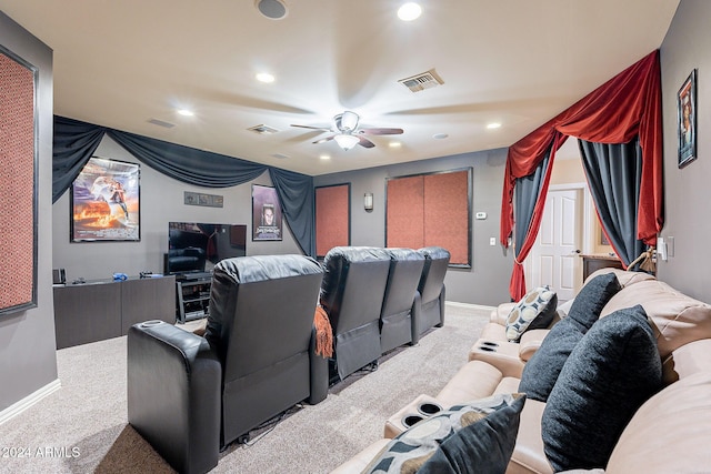 cinema room with ceiling fan and light carpet