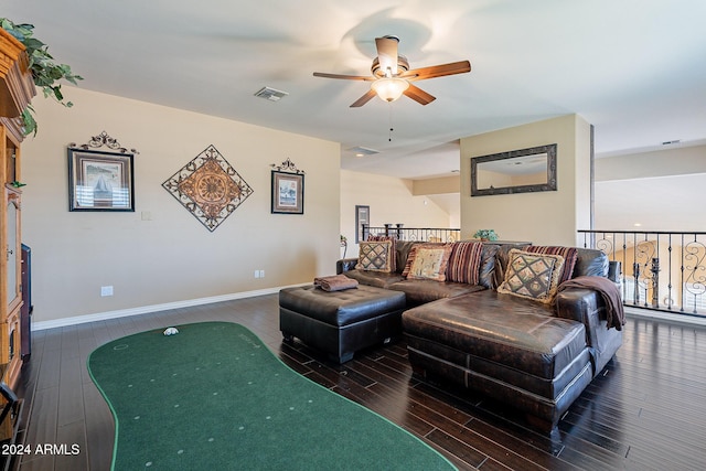 living room featuring ceiling fan and dark hardwood / wood-style floors