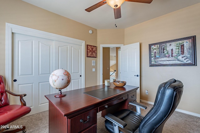 carpeted office featuring ceiling fan