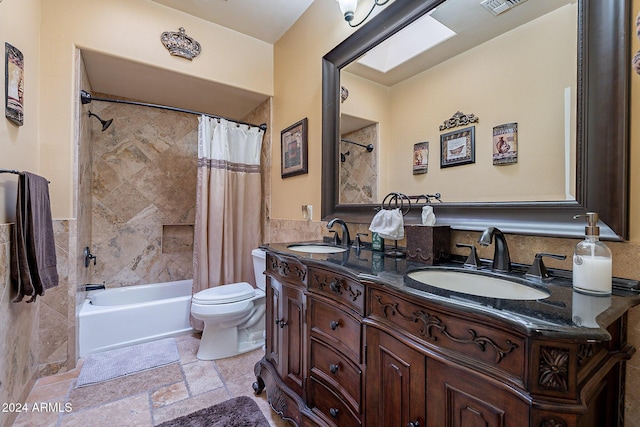 full bathroom featuring shower / tub combo, vanity, and toilet