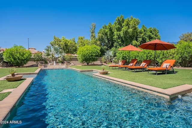 view of swimming pool with a lawn