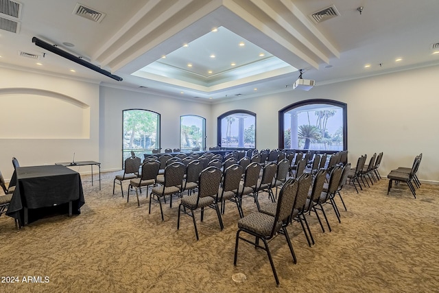 carpeted home theater room featuring crown molding