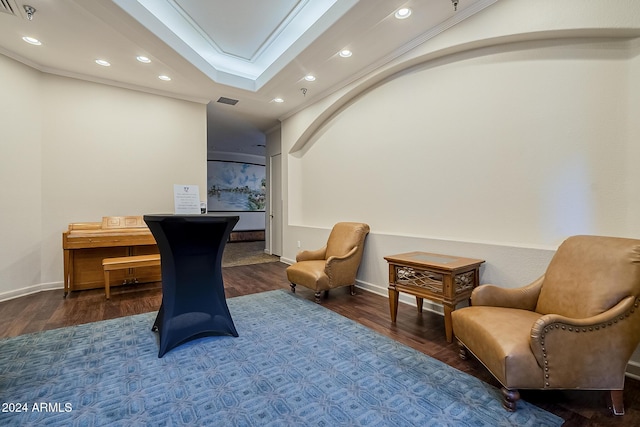 sitting room with hardwood / wood-style flooring and ornamental molding