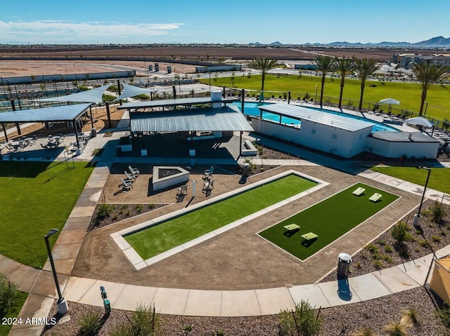 drone / aerial view of a pool and a mountain backdrop
