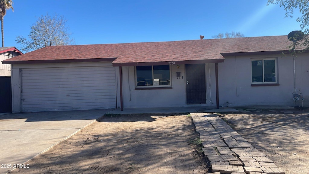 single story home featuring a garage