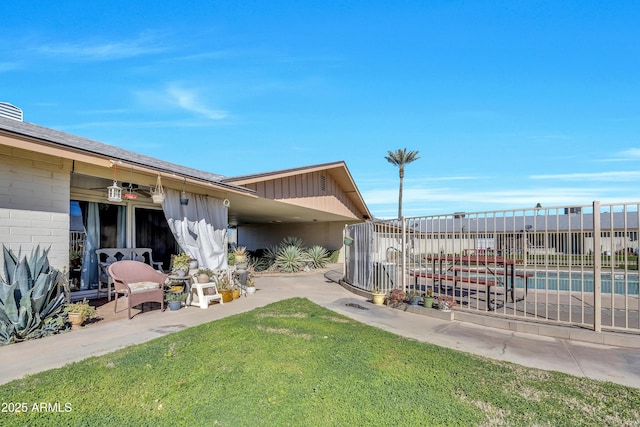 view of yard with a patio area, fence, and a fenced in pool