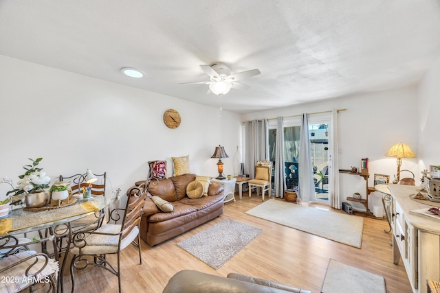 living area featuring a ceiling fan and light wood-style flooring