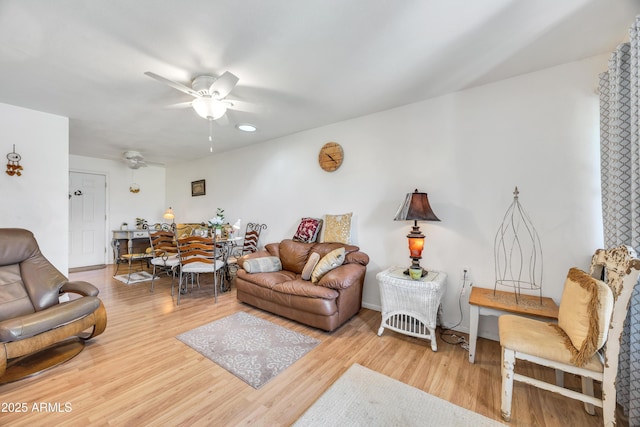 living area featuring a ceiling fan and wood finished floors