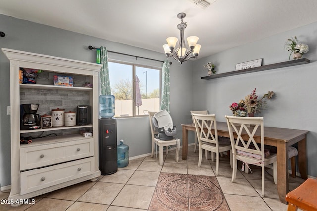 dining area with an inviting chandelier and light tile patterned flooring