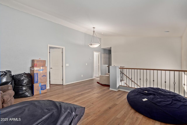 living area with hardwood / wood-style flooring and lofted ceiling