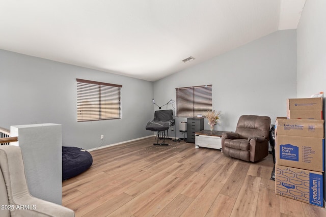 sitting room with lofted ceiling and light hardwood / wood-style flooring