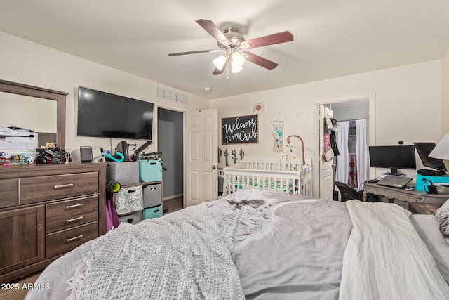 bedroom with a walk in closet, a closet, and ceiling fan