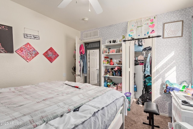 carpeted bedroom featuring ceiling fan and a closet