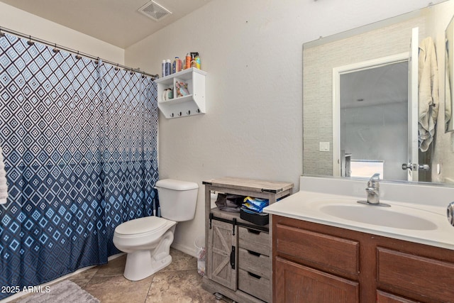 bathroom with vanity, tile patterned floors, and toilet